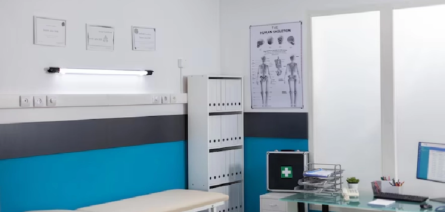 Modern healthcare clinic room with medical posters and equipment