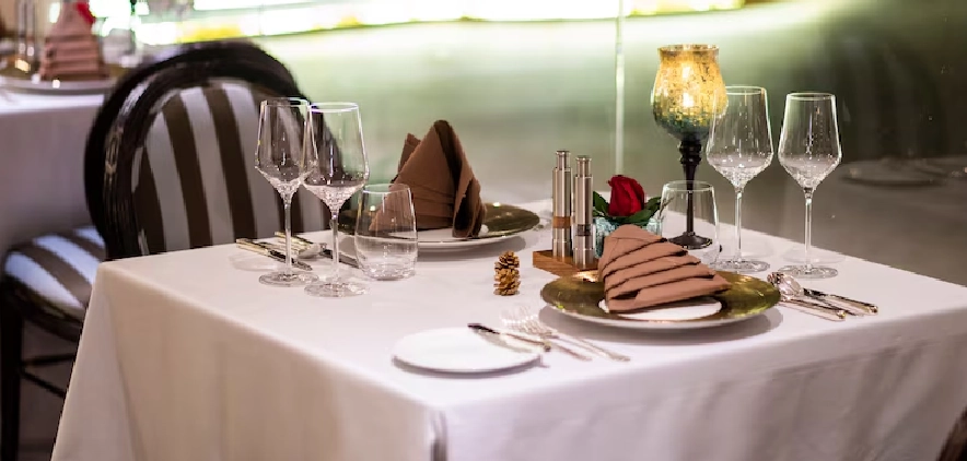 Elegant restaurant dining table set with glasses and plates